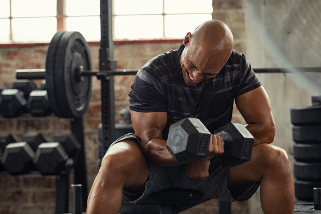 Man in his forties performing dumbbell exercises with proper form
